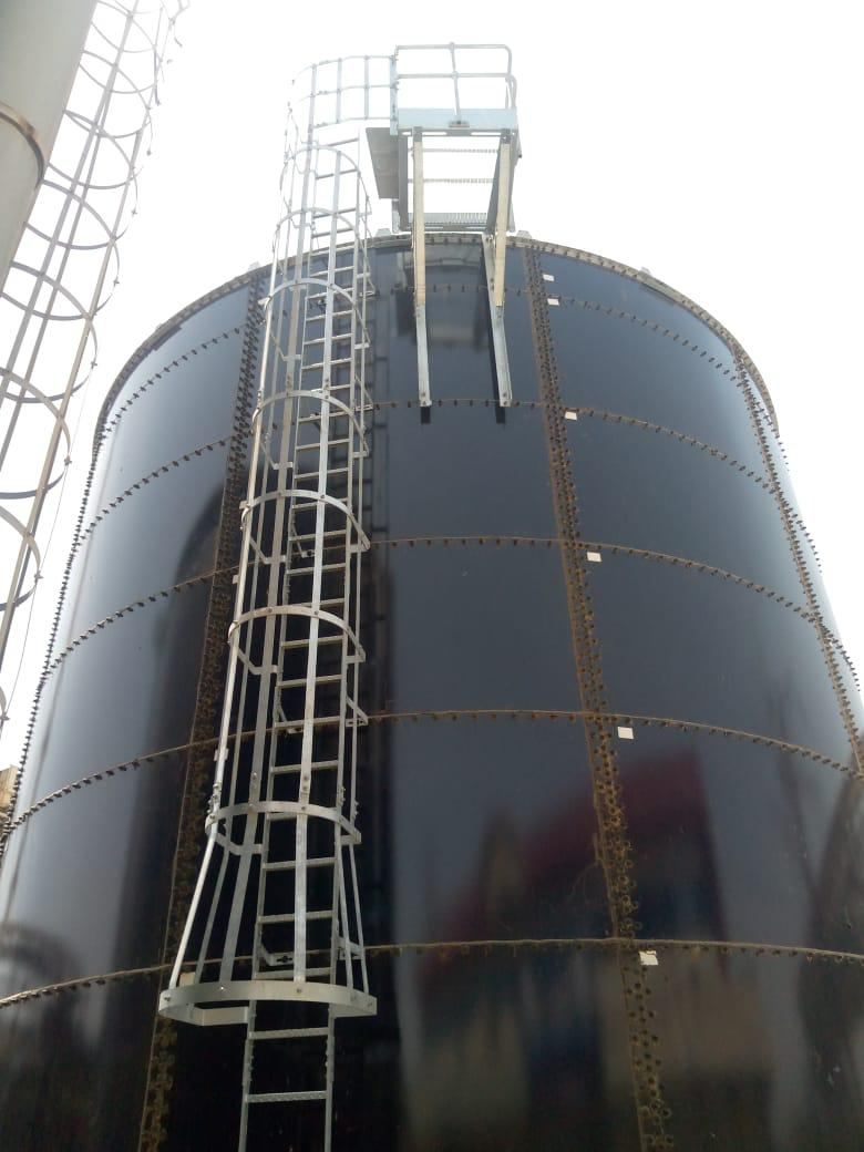Caged access ladder and top platform fitted to a glass-fused bolted storage tank